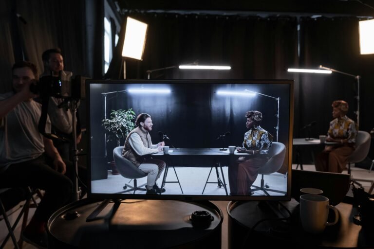 A podcast recording session in a studio with hosts in conversation, captured on screen.